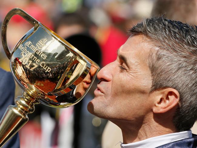 MELBOURNE, AUSTRALIA - NOVEMBER 07:  Corey Brown, jockey of Rekindling kisses the Emirates Melbourne Cup during Melbourne Cup Day at Flemington Racecourse on November 7, 2017 in Melbourne, Australia.  (Photo by Darrian Traynor/Getty Images)