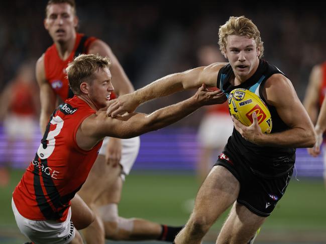 Jason Horne-Francis fends off Darcy Parish as he streams out of the centre square again in Round 4. Picture: Michael Klein