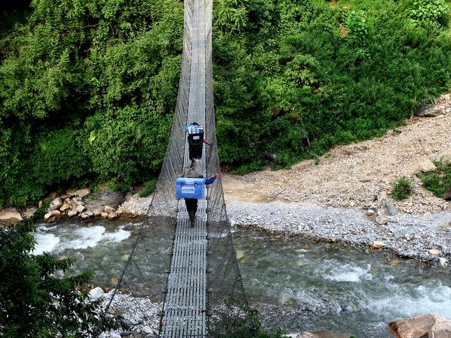 Porters and a local health official carry UNICEF-provided vaccines on difficult terrains on the way to a health post in the Gorkha District, Nepal, the epicentre of the April 25, 2015 earthquake that killed nearly 9000 people.