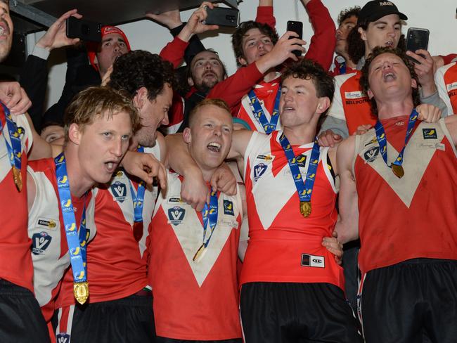 Red Hill players and supporters belt out the club song after winning the MPNFL Division 2 grand final last season. Picture:Chris Eastman