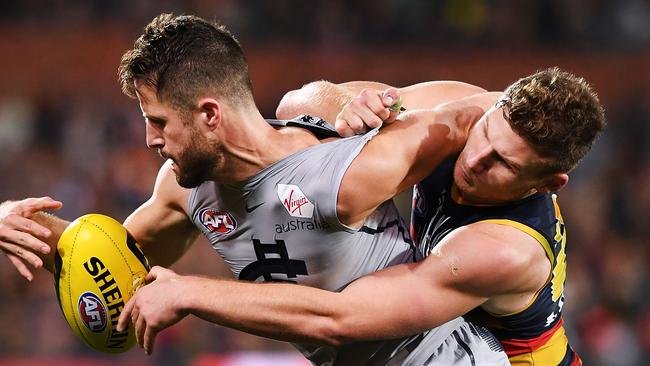 Adelaide’s Rory Laird tackles former Crow Matthew Wright in May. They face off again in the last round. Picture: Mark Brake/Getty Images