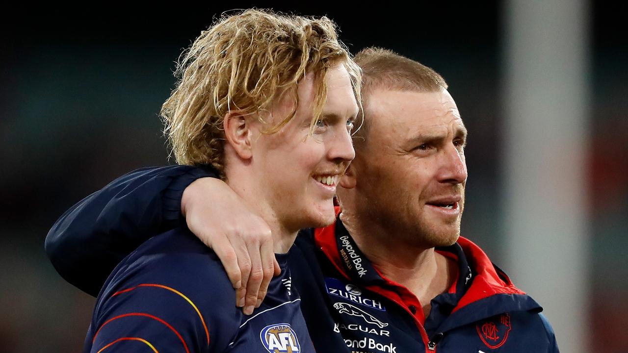 MELBOURNE, AUSTRALIA - SEPTEMBER 09: Clayton Oliver of the Demons and Simon Goodwin, Senior Coach of the Demons are seen during the 2022 AFL Second Semi Final match between the Melbourne Demons and the Brisbane Lions at the Melbourne Cricket Ground on September 9, 2022 in Melbourne, Australia. (Photo by Dylan Burns/AFL Photos via Getty Images)