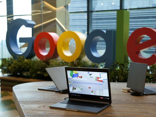 Google Inc. Chromebook laptop computers sit on display in front of a sign featuring the company's logo at the company's Asia-Pacific headquarters during its opening day in Singapore, on Thursday, Nov. 10, 2016. Google officially opened its new hub in Singapore today. Photographer: Ore Huiying/Bloomberg