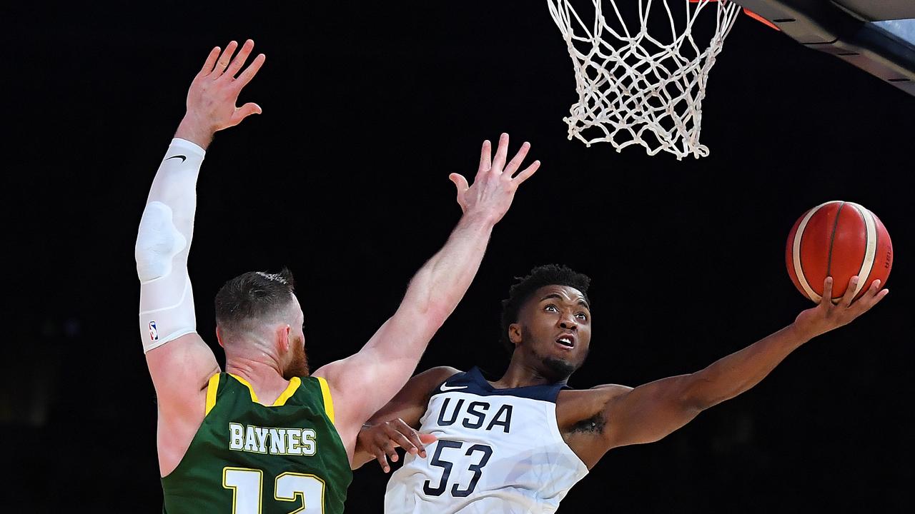 Donovan Mitchell of the USA shoots over Aron Baynes. (Photo by Quinn Rooney/Getty Images)