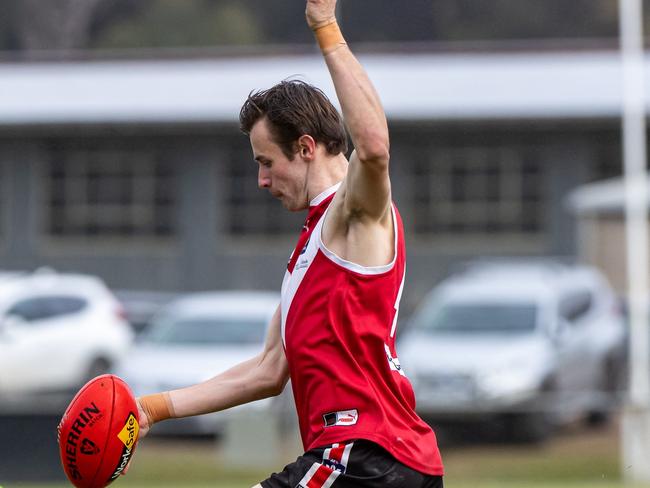 Patrick MacDonald takes a kick for Red Hill. Picture: Alan Dillon