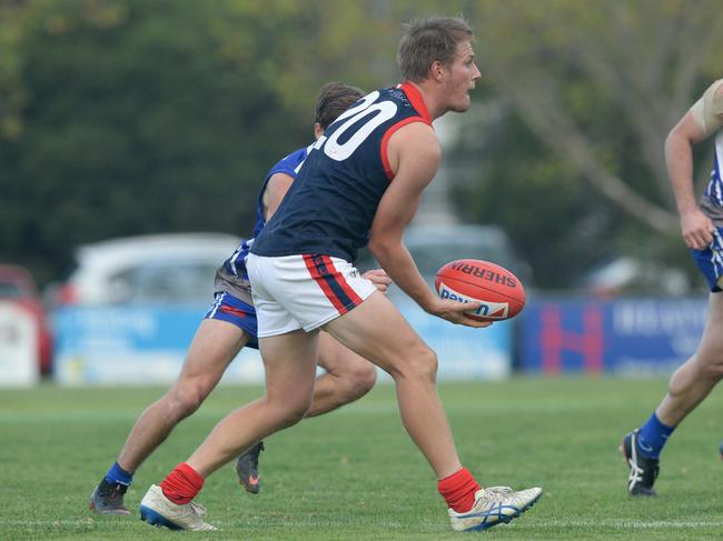 Sam Gibson dishes off a handball last year. Picture: Chris Eastman/AAP