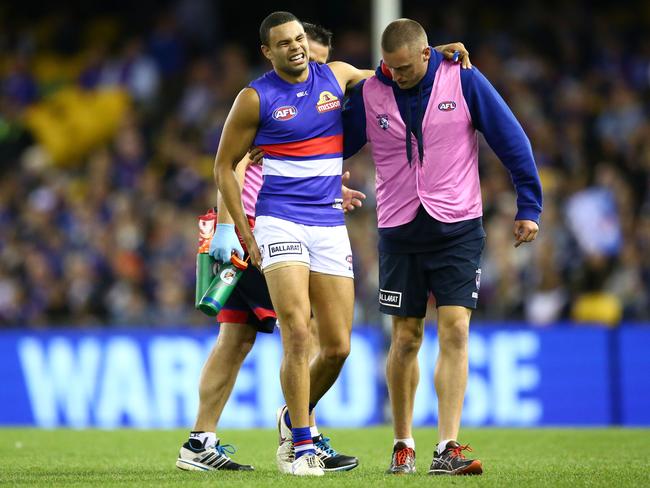 Jason Johannisen of the Bulldogs leaves the field injured