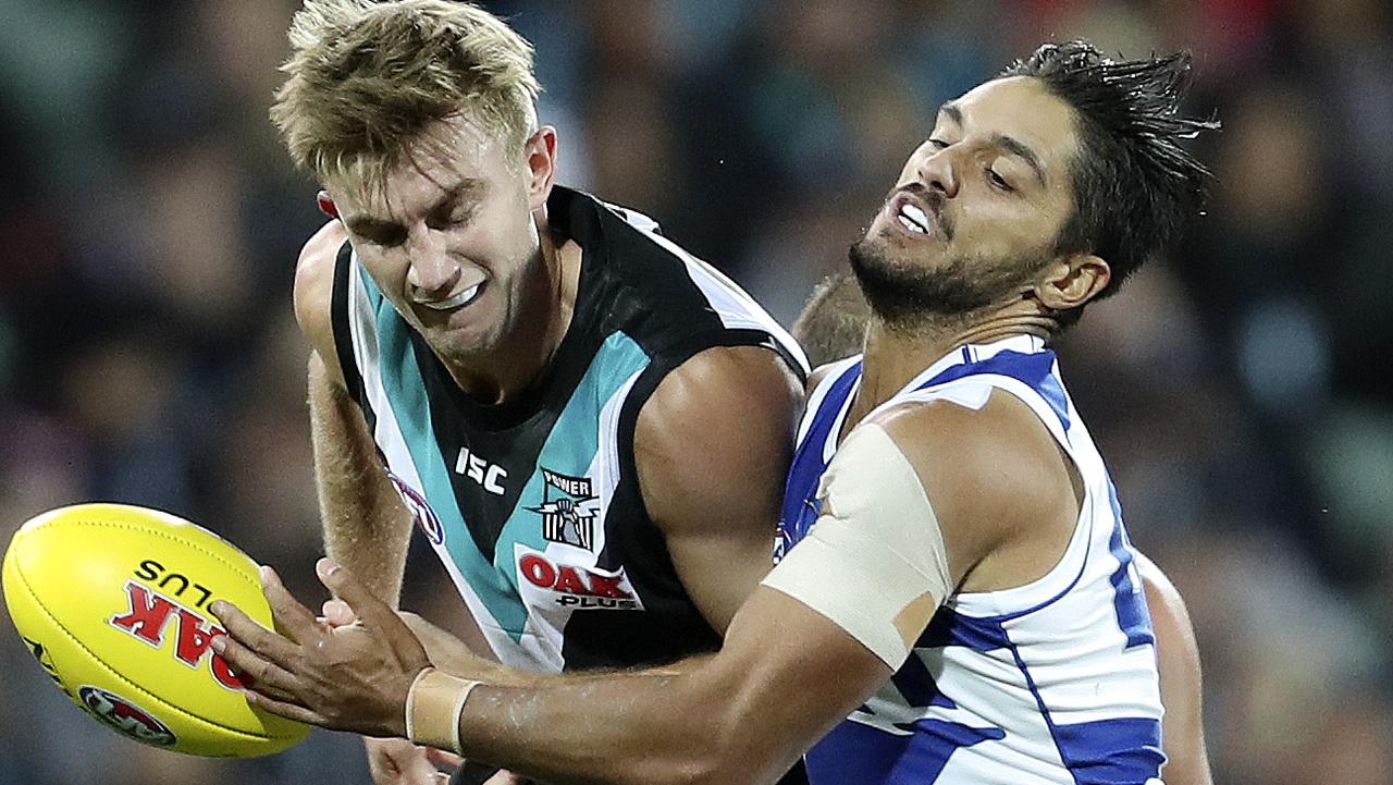 GOING NOWHERE: Dougal Howard is tackled by North Melbourne’s Aaron Hall on Friday night. Picture: SARAH REED.