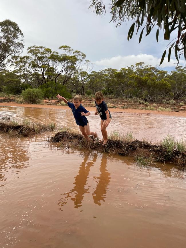 Children play in flood waters after heavy rain at Cortlinye, near Kimba. Picture: Laura Gillett