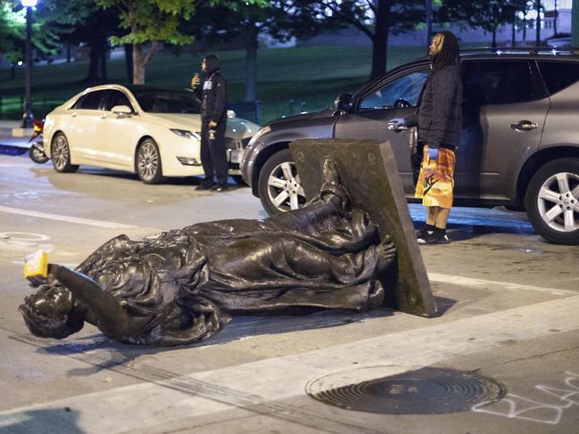 Wisconsin's "Forward" statue lies in the street on Capitol Square in Madison. Picture: AP