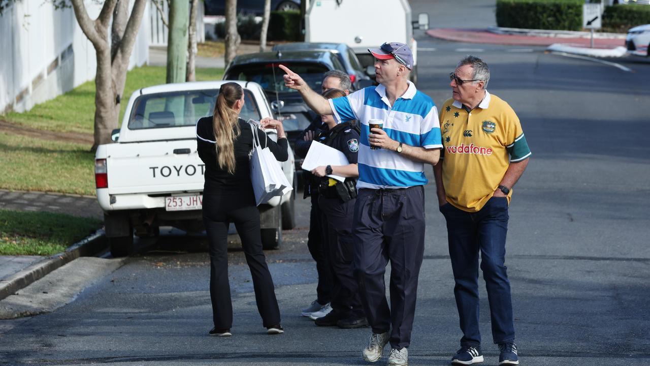 Mr Topp and a neighbour at the scene on Sunday. Picture: Lachie Millard