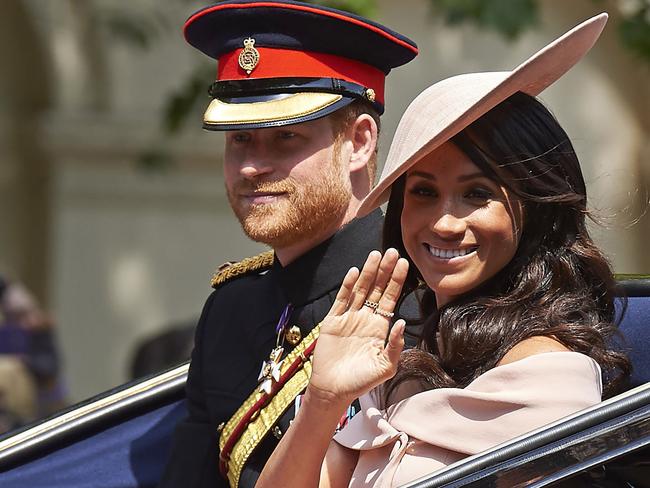 Britain's Prince Harry, Duke of Sussex and Britain's Meghan, Duchess of Sussex return in a horse-drawn carriage after attending the Queen's Birthday Parade, 'Trooping the Colour' on Horseguards parade in London on June 9, 2018.   The ceremony of Trooping the Colour is believed to have first been performed during the reign of King Charles II. In 1748, it was decided that the parade would be used to mark the official birthday of the Sovereign. More than 600 guardsmen and cavalry make up the parade, a celebration of the Sovereign's official birthday, although the Queen's actual birthday is on 21 April. / AFP PHOTO / Niklas HALLEN