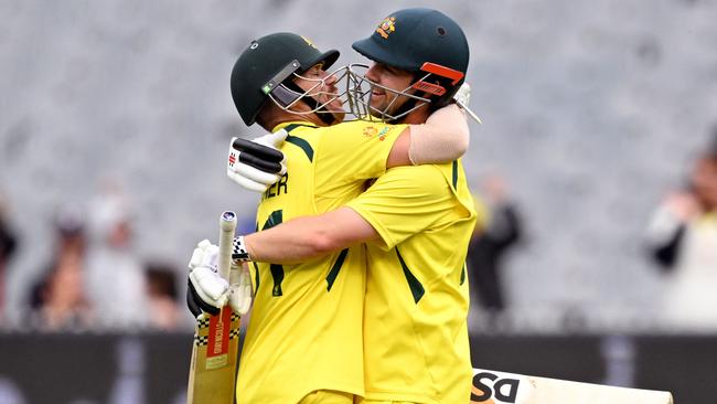 Australia's Travis Head (R) is embraced by teammate David Warner