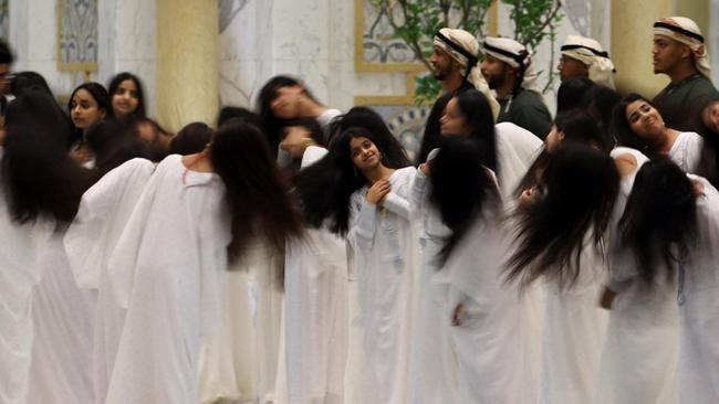 Young women perform the hair dance for Donald Trump.
