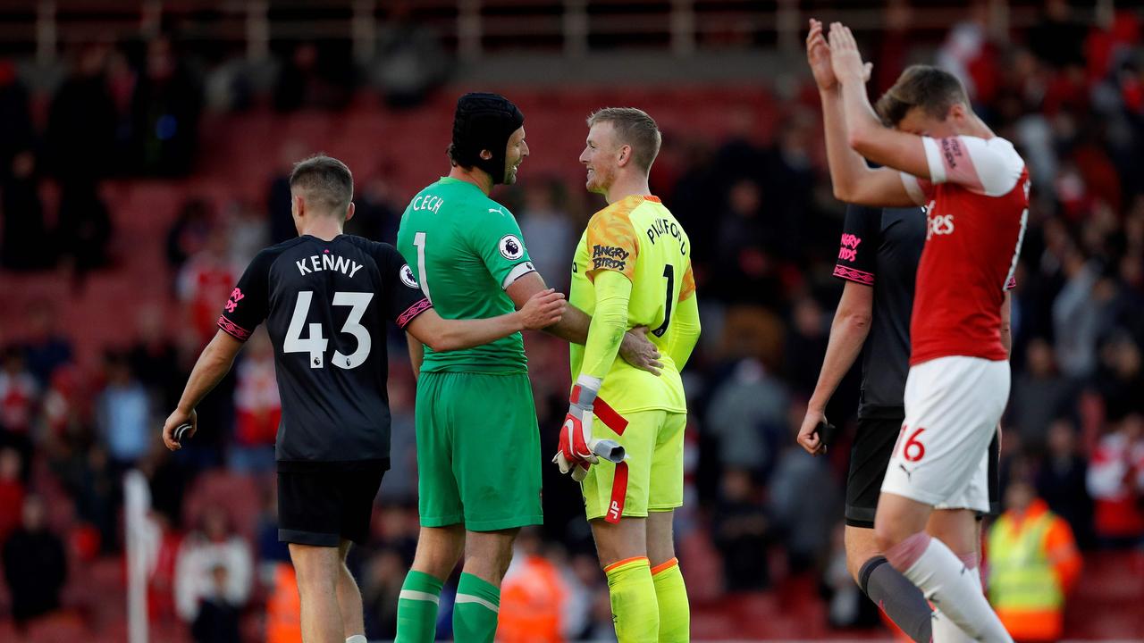 Cech and Pickford embrace after the game.