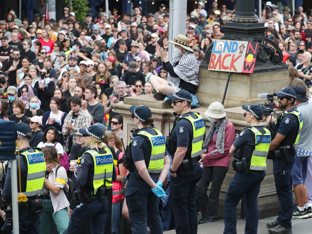 Police watching on at the rally. Picture: David Crosling