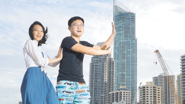 Chinese tourists Dongwan Wang and Weihua Chen having fun on Surfers Paradise beach. Picture by Scott Fletcher