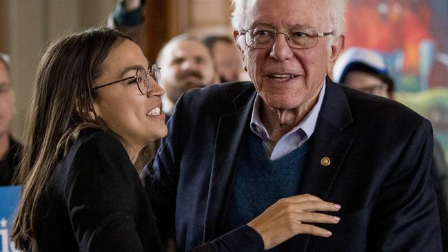 Alexandria Ocasio-Cortez welcomes Bernie Sanders to the podium in Perry, Iowa, on Monday. Picture: AP