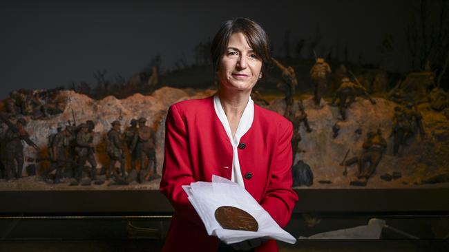 Australian War Memorial guide Krista Vane-Tempest with the commemorative plaque honouring her great-aunt Edith Blake. Picture: Martin Ollman