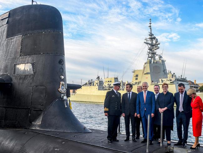 French President Emmanuel Macron (second from left) and then-Australian Prime Minister Malcolm Turnbull (centre) stand on the deck of HMAS Waller in 2018. Picture: AFP