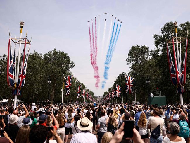 Members of the public cheer as they watch the Royal Air Force Aerobatic Team, the Red Arrows during the King's Birthday Parade, 'Trooping the Colour', in London. Picture: Henry Nicholls / AFP