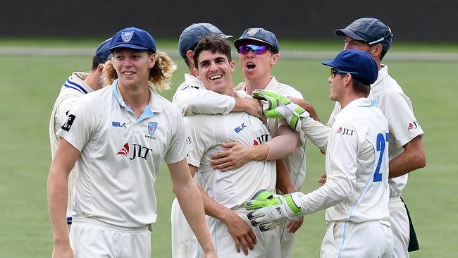 New South Wales bowler Sean Abbott (centre) is mobbed by teammates. Picture: AAP