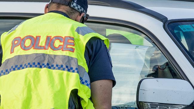 A driver showing a note to police. Picture: Jerad Williams