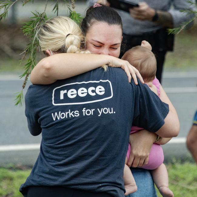 Evacuees reunite with family members at the Barron River Bridge after being rescued by boats. Picture: Brian Cassey/NCA Newswire