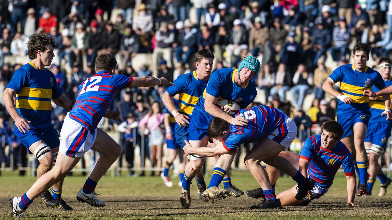 Oliver Chaffey of Grammar is tackled by Jake Stephens of Downlands in O'Callaghan Cup on Grammar Downlands Day at Downlands College, Saturday, August 6, 2022. Picture: Kevin Farmer