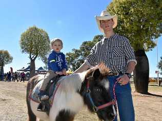 HORSING AROUND: Henry Williamson hitches a ride at last year's Roma Fun Day with Ashley Smith. Picture: Joshua Macree