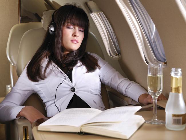 Young business woman sleeping and enjoying the flight in the small private airplane.