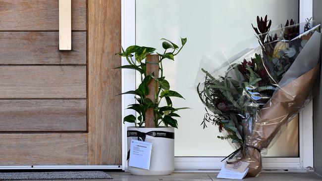 Flowers and a potted plant were left at the front door of Melissa Caddick’s family home in Dover Heights yesterday. Picture: NCA NewsWire/Bianca De Marchi