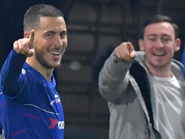 Chelsea's Belgian midfielder Eden Hazard celebrates after scoring their second goal during the English Premier League football match between Chelsea and West Ham United at Stamford Bridge in London on April 8, 2019. - Hazard scored both goals as Chelsea won the game 2-0. (Photo by OLLY GREENWOOD / AFP) / RESTRICTED TO EDITORIAL USE. No use with unauthorized audio, video, data, fixture lists, club/league logos or 'live' services. Online in-match use limited to 120 images. An additional 40 images may be used in extra time. No video emulation. Social media in-match use limited to 120 images. An additional 40 images may be used in extra time. No use in betting publications, games or single club/league/player publications. /