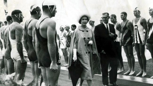 Queen Elizabeth II walks along a Gold Coast street lined with lifesavers during her 1963 tour. Picture: File.