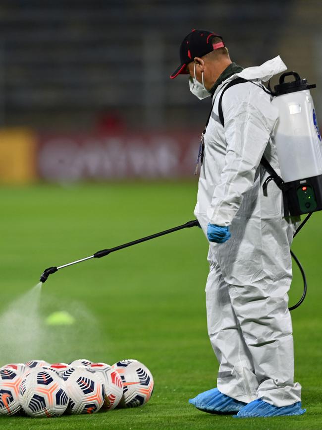 The balls are disinfected before the match between Palestino and Cobresal. Picture: AFP