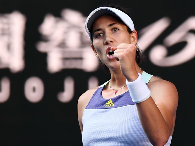 Spain's Garbine Muguruza celebrates after beating Romania's Simona Halep during their women's singles semi-final match on day eleven of the Australian Open tennis tournament in Melbourne on January 30, 2020. (Photo by William WEST / AFP) / IMAGE RESTRICTED TO EDITORIAL USE - STRICTLY NO COMMERCIAL USE