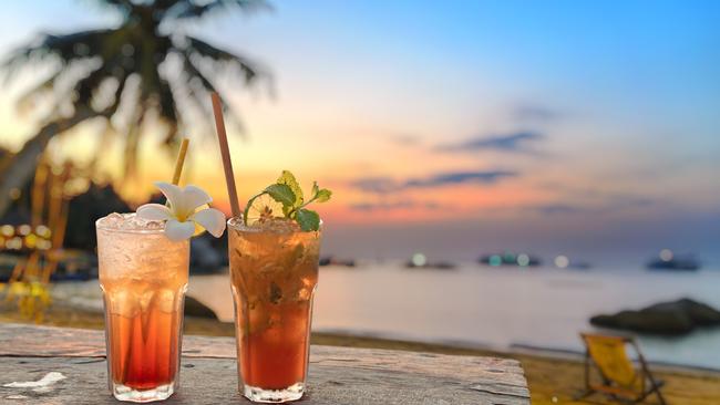 drinks with blur beach and sunset in background