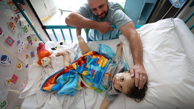 Harlen recovering from the transplant with his dad Matt Busuttil watching over him in Cockatoo Ward. Picture: David Caird