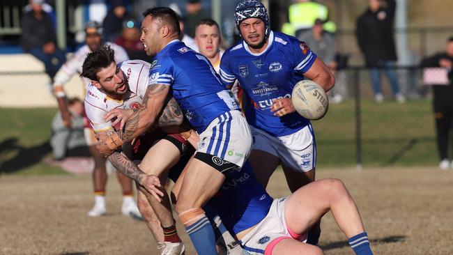 Thirlmere's Curtis Scott passes around Narellan’s (No.7) Levi Dodd. Picture: Steve Montgomery