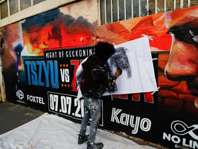 Painters replace Michael Zerafa on the mural to promote the upcoming fight between Tim Tszyu and Zerafa's replacement. Picture: Getty