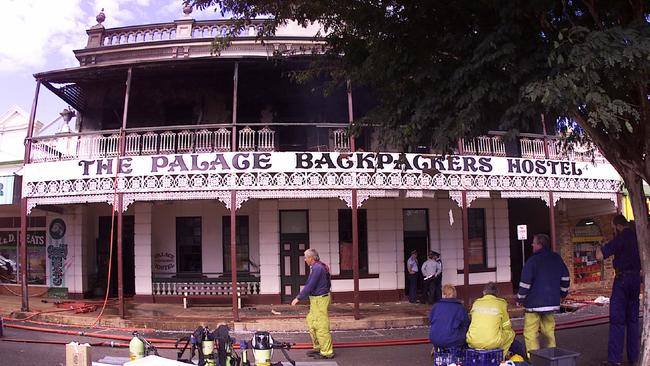 Police &amp; SES officers outside Palace Backpackers Hostel in Childers after the 2000 fire. Pic Anthony Weate.