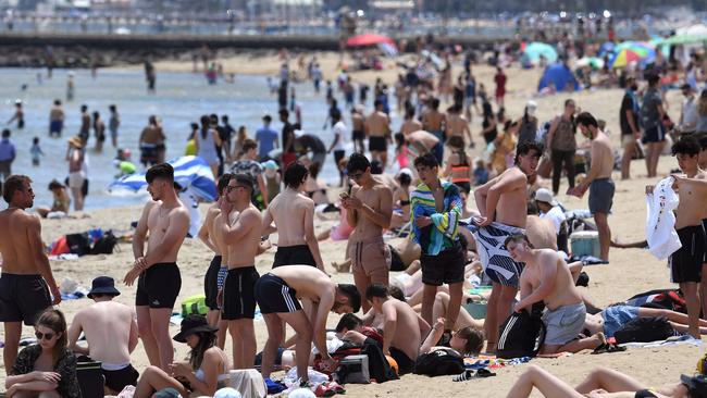 People enjoy the warm Cup Day weather. Picture: William West/AFP