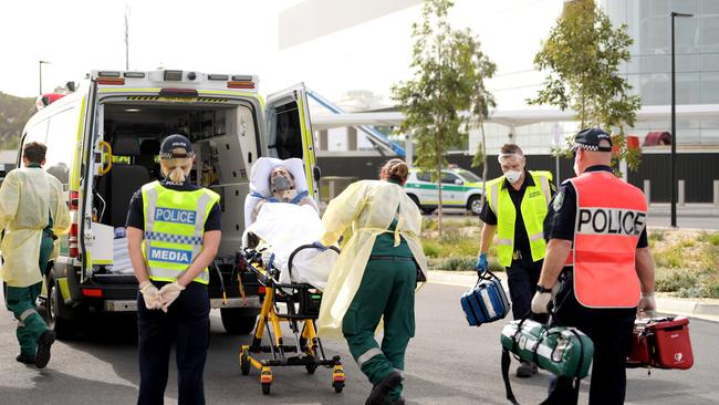 An Australian traveller is seen on a stretcher after returning home at Adelaide International Airport. Picture: Getty Images