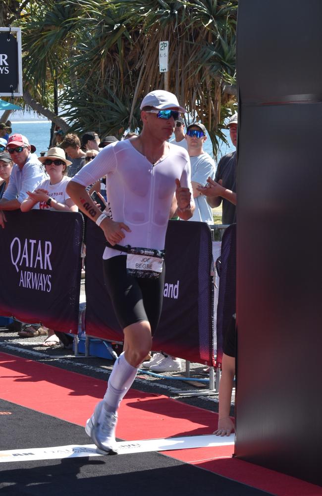 Athletes crossing the finish line at Sunshine Coast Ironman 70.3 2023.