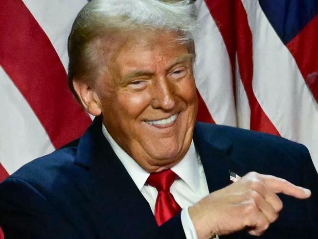 Former US President and Republican presidential candidate Donald Trump points to his wife former US First Lady Melania Trump during an election night event at the West Palm Beach Convention Center in West Palm Beach, Florida, early on November 6, 2024. (Photo by Jim WATSON / AFP)