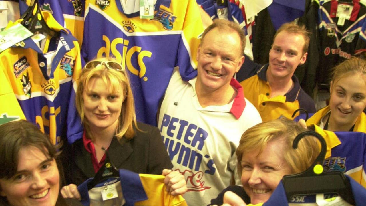 Wynn with supporters madly buying up Eels merchandise ahead of the 2001 grand final. Picture: Jeff Herbert.