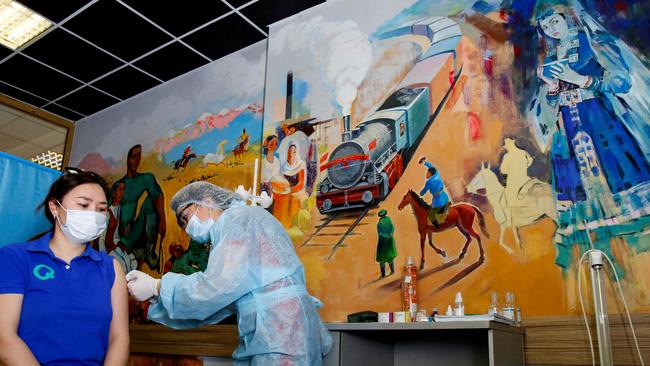 A woman receives a dose of the Sputnik V (Gam-Covid-Vac) vaccine against the coronavirus disease at a vaccination point in the Abylkhan Kasteyev State Museum of Arts of the Republic of Kazakhstan. Picture: AFP