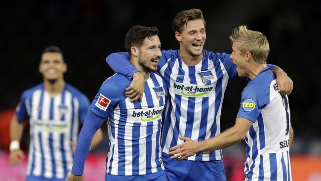 Hertha's scorer Mathew Leckie, front left, and his teammates celebrate