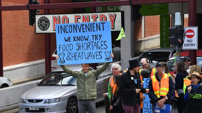 The activists from Extinction Rebellion wait at the lights ... Picture: AAP Image/David Mariuz