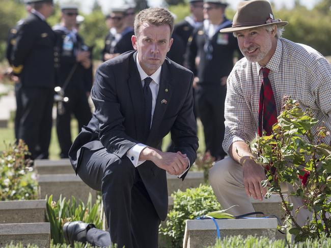 Australian Minister for Veterans' Affairs Dan Tehan places a cross on the headstone of sergeant William Allen from his electorate of Wannon. Next to him is Graham Robertson, 57, from Sydney. Picture: Ella Pellegrini